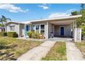 Charming single-story home with carport, gray siding, blue doors and simple landscaping at 6720 Northampton Pl, Bradenton, FL 34207
