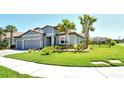 Charming home showcasing a verdant lawn, three-car garage, and swaying palm trees, creating a tranquil setting at 6800 Dunlin Ct, Sarasota, FL 34241