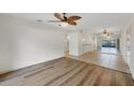 Open living area featuring hard surface floors, ceiling fan, and access to the kitchen at 752 White Pine Tree Rd # 101, Venice, FL 34285