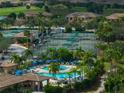 Aerial view of resort style pool, tennis courts, and well maintained landscaping in this community at 8205 Grand Estuary Trl # 101, Bradenton, FL 34212