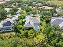 Aerial view of a landscaped property with a pool and screened-in lanai at 8838 Bloomfield Blvd, Sarasota, FL 34238