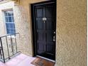 Close-up of the unit's front door with a black finish and welcome mat at 105 S Obrien St # 213, Tampa, FL 33609