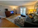 Comfortable living room with stylish furniture, neutral walls, and glass doors to the balcony at 105 S Obrien St # 213, Tampa, FL 33609