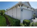 The side of a home with a three-car garage, tidy landscaping and lawn at 11713 Goldenrod Ave, Bradenton, FL 34212