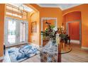 Inviting foyer with glass double doors, a decorative chandelier, and a glass table at 12012 Legacy Estates Blvd, Sarasota, FL 34238