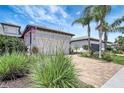 Charming home with a two-car garage, paved driveway, well-maintained landscaping, and American flag at 12291 Myrtle Bay Ct, Sarasota, FL 34238