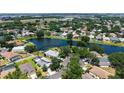 Serene aerial view showcasing a home near a scenic lake and surrounded by lush greenery and other residences at 12339 Hollybush Ter, Lakewood Ranch, FL 34202
