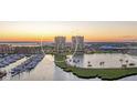Scenic waterfront condos with a marina and serene lake view at sunset at 130 Riviera Dunes Way # 903, Palmetto, FL 34221