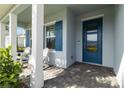 Charming front porch with pavers and Adirondack chairs at 16148 Preservation Blvd, Punta Gorda, FL 33982