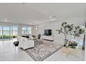 Well-lit living room with a neutral color scheme, stylish decor, and water views at 16148 Preservation Blvd, Punta Gorda, FL 33982