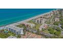 Beautiful aerial view of the beachfront condo complex with a pristine sandy beach and blue ocean waters at 1701 Gulf Of Mexico Dr # 502, Longboat Key, FL 34228