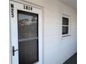 Condominium doorway featuring the unit number and exterior window at 1819 Restful Dr # N25, Bradenton, FL 34207