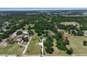 Establishing aerial shot of home and property in lush, wooded community at 2040 Edmondson Rd, Nokomis, FL 34275