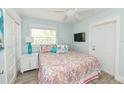 Cozy bedroom featuring a comfortable queen-sized bed and ample natural light from the window at 205 Elm Ave, Anna Maria, FL 34216