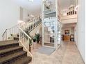 Building lobby featuring stairs and a modern glass elevator with stylish tile flooring at 21300 Brinson Ave # 214, Port Charlotte, FL 33952