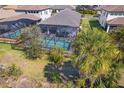 Aerial view of screened-in pool with mature landscaping, perfect for outdoor relaxation at 224 Caserta Ct, Nokomis, FL 34275