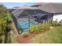 Screened pool features an inviting area for relaxation and entertaining, surrounded by lush plantings at 224 Caserta Ct, Nokomis, FL 34275