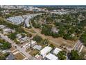 Aerial view of a neighborhood near a city with tree-lined streets, single-Gathering homes, and modern townhomes at 2365 Novus St, Sarasota, FL 34237