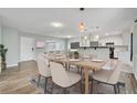 Open dining area connected to living room and kitchen, featuring a stylish table set for six at 2705 20Th Avenue W Dr, Bradenton, FL 34205
