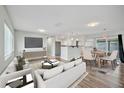 Bright, open-concept living and dining area with hardwood floors and modern furniture at 2705 20Th Avenue W Dr, Bradenton, FL 34205