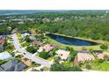 Gorgeous aerial view of the property, backing to a peaceful pond and surrounding community at 3201 Wilderness W Blvd, Parrish, FL 34219
