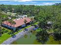 Wonderful aerial view of condo near pond with lovely greenery and a rock wall at 3500 El Conquistador Pkwy # 301, Bradenton, FL 34210
