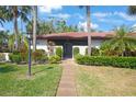 Lovely condo exterior with a well-maintained lawn and tropical foliage at 3500 El Conquistador Pkwy # 301, Bradenton, FL 34210