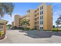 The building has manicured landscaping with mature palm trees and reserved parking for visitors at 3750 Pinebrook Cir # 104, Bradenton, FL 34209
