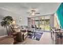 Inviting living room featuring a comfortable sectional sofa and sliding glass doors leading to a patio at 3750 Pinebrook Cir # 104, Bradenton, FL 34209