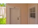 Inviting condo entrance with a secure door, exterior window, and visible unit number 111 at 4264 Central Sarasota Pkwy # 111, Sarasota, FL 34238