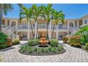 Beautiful condo exterior with a water fountain, manicured garden, and elegant stairways at 4264 Central Sarasota Pkwy # 111, Sarasota, FL 34238