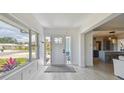 Bright foyer featuring a large window, white door, and light hardwood floors with access to the main living areas at 4309 Pinfish Ln, Palmetto, FL 34221