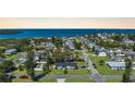 Wide aerial shot of a cozy neighborhood near the water, with a blue home and green lawn at 4403 5Th W Ave, Palmetto, FL 34221