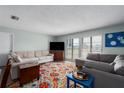 Comfortable living room featuring neutral-toned couches and a bright, colorful rug at 4403 5Th W Ave, Palmetto, FL 34221