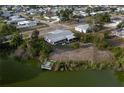 Aerial view showcasing waterfront lot, mature trees and an enclosed porch at 512 Shamrock Blvd, Venice, FL 34293