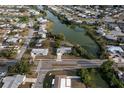 Wide aerial shot showcasing the neighborhood with lake views and mature greenery at 512 Shamrock Blvd, Venice, FL 34293