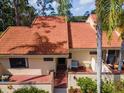 Charming single-Gathering home featuring a red tiled roof, brick-paved patio and entry, with a secure gated entrance at 5336 Huntingwood Ct # 24, Sarasota, FL 34235