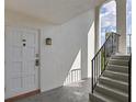 Exterior entryway with stairs, white door, and stylish light fixture illuminating the space at 5800 Hollywood Blvd # 312, Sarasota, FL 34231