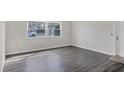 Bright living room featuring sleek gray flooring and a large window with natural light at 5800 Hollywood Blvd # 312, Sarasota, FL 34231