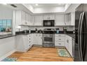Modern kitchen with stainless steel appliances, white cabinets, and granite countertops for a sleek design at 6218 29Th W Ave # 6218, Bradenton, FL 34209