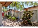 Property exterior view with manicured landscaping, secure fencing, and a charming walkway leading to the entrance at 6304 Pelican Dr, Bradenton, FL 34210