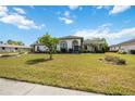 Attractive single-story home with arched entryway, manicured lawn and decorative flower beds at 6405 99Th E St, Bradenton, FL 34202
