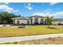 Inviting one-story home featuring a well-maintained lawn and a welcoming front facade at 6405 99Th E St, Bradenton, FL 34202