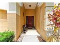 Charming covered front porch with seating, and a lovely front door with decorative glass at 6546 Blue Grosbeak Cir, Lakewood Ranch, FL 34202