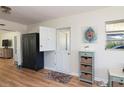 Inviting entryway featuring a rustic wooden floor, quaint furniture, and charming decor at 91 39Th Street Nw Ct, Bradenton, FL 34205