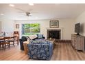 Bright living room with a fireplace, wood floors, and a view to the outdoor area at 91 39Th Street Nw Ct, Bradenton, FL 34205