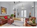 Open-concept living room featuring a comfortable seating arrangement, hardwood floors, and stylish decor at 11447 Savannah Lakes Dr, Parrish, FL 34219