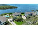 Aerial view of a waterfront home showcasing its beautiful location and nearby pool at 12 Tidy Island Blvd, Bradenton, FL 34210