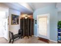 Inviting entryway featuring tile flooring, bench, and a decorative screen at 12026 Warwick Cir, Parrish, FL 34219