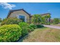 Beautiful single-Gathering home with a well-maintained lawn, lush bushes and attractive landscaping at 12315 Canavese Ln, Venice, FL 34293